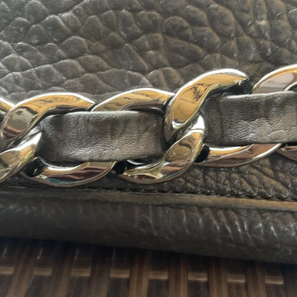 Michael kors Pebbled leather MK clutch with gun metal zipper.